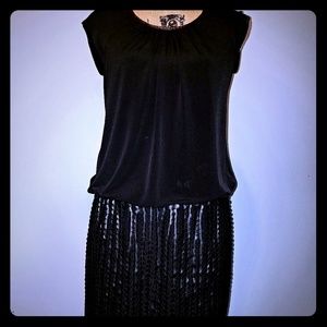 Sleeveless black dress.